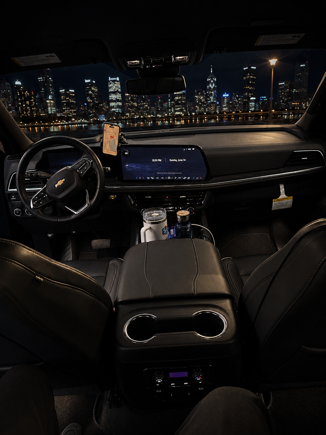 Interior cockpit view of the 2026 Chevy Suburban with dashboard and city skyline ahead