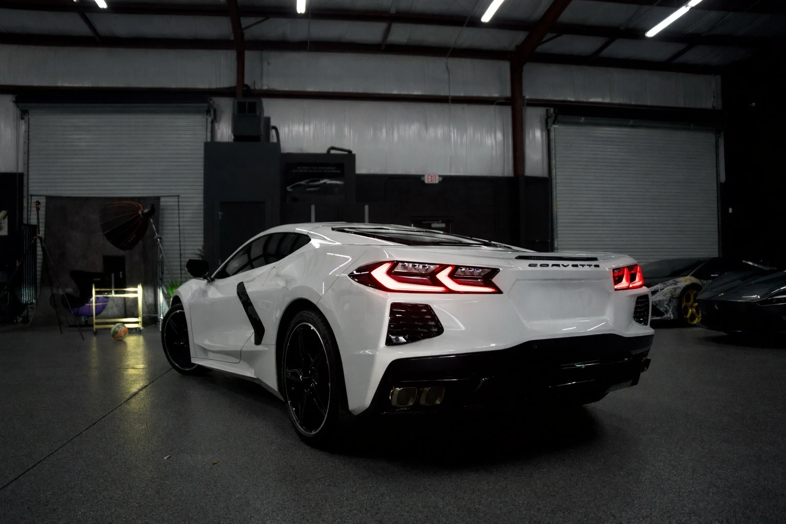 White Chevrolet Corvette C8 — rear three-quarter view
