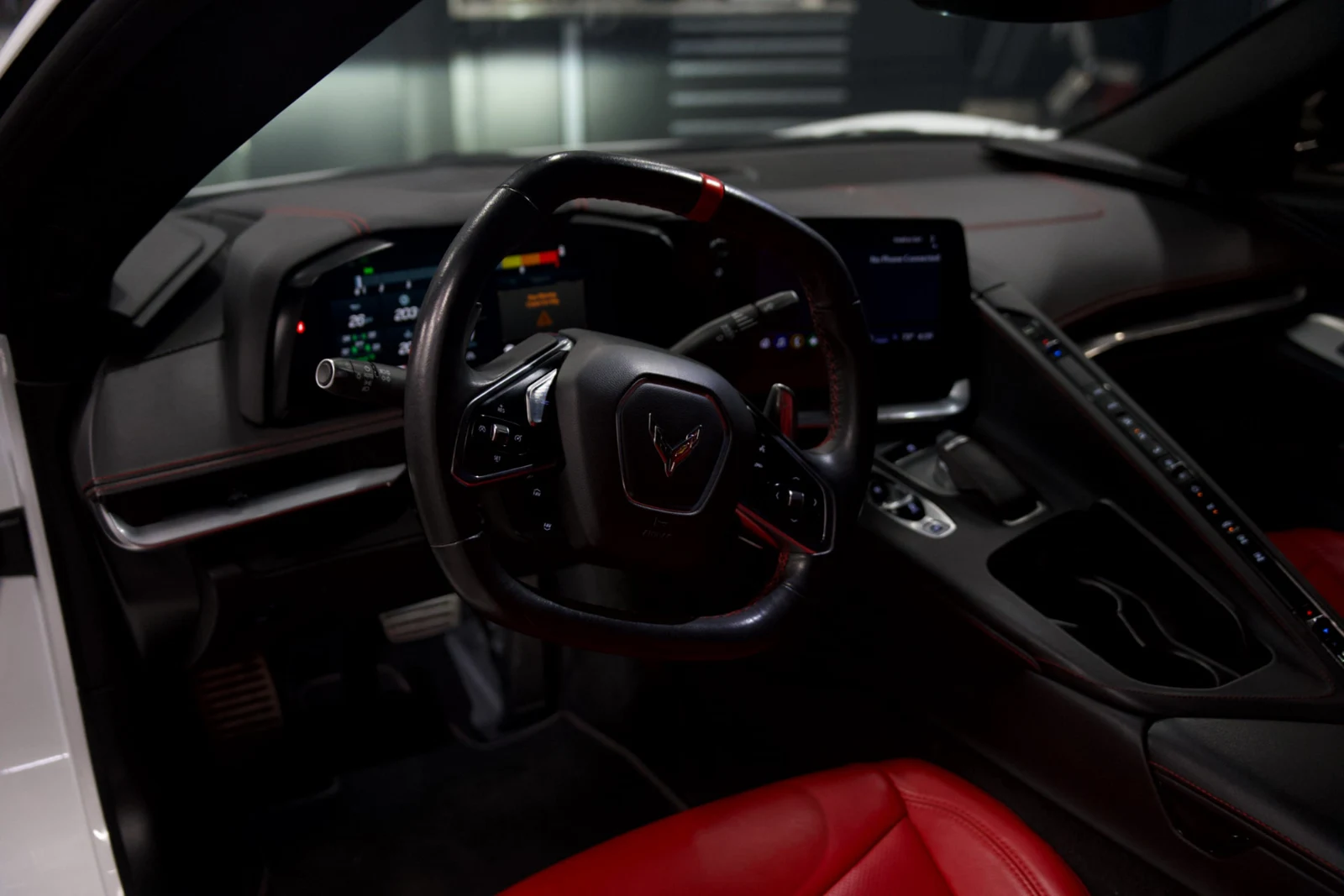 White Chevrolet Corvette C8 — interior dashboard and steering wheel